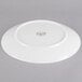 A white Reserve by Libbey porcelain coupe plate with a circular design on it.