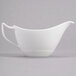A close-up of a white Reserve by Libbey Royal Rideau sauce boat.