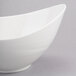 A white oval bowl with a curved edge.