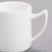 A white Royal Rideau porcelain mug with a handle.