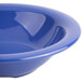 A close-up of a Carlisle Ocean Blue rimmed melamine bowl.