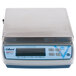 An Edlund BRAVO! digital portion scale with a blue top and a silver base on a black surface.