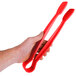 A hand holding a pair of red Thunder Group tongs.