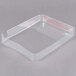 A clear plastic tray with red writing on a small piece of paper inside.