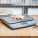 An Edlund BRAVO! digital portion scale with food on it.