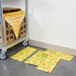 A cart with a stack of yellow Spilfyter absorbent pads.