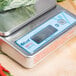 An Edlund BRAVO! digital portion scale with vegetables on top.