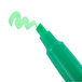 A close-up of a Universal green chisel tip highlighter pen.