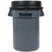 A gray 32 gallon round trash can with a black funnel top lid.