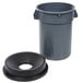 A gray round trash can with a black funnel top lid.