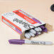 A box of Sharpie purple fine point permanent markers.