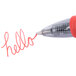 A close-up of a red Pilot G2 pen with "hello" written in gel ink.