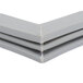 A grey plastic corner piece with two pieces of plastic on white background.
