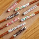 Phillips White Chocolate Ice Cream Cone Dip coating on pretzels with sprinkles.