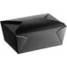 A black folded paper take-out container with a lid.