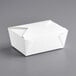 A white Choice folded paper take-out container on a gray surface.