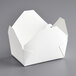 A white folded paper take-out box with a lid.