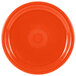 A close-up of a Fiesta® orange china plate with a circular rim.