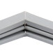 A close-up of a gray metal corner piece for a Traulsen refrigerator door gasket.