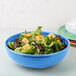 A Fiesta Lapis blue china bistro bowl filled with salad and croutons.