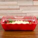 A red Cambro deli crock on a counter in a salad bar.