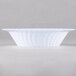 A close up of a white Fineline Flairware plastic bowl with a wavy design.