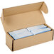A white cardboard box with two blue boxes of blue self-adhering customizable paper napkin bands inside.
