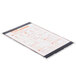 A Menu Solutions Alumitique aluminum menu board holding a white and orange paper menu on a white surface.