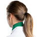 A woman wearing a green Intedge chef neckerchief with a ponytail.