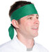 A man wearing a green Intedge chef bandana on his head.