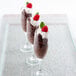 A group of GET SAN Plastic Champagne Flutes filled with chocolate mousse and raspberries.