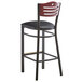 A Lancaster Table & Seating black bistro bar stool with a black vinyl seat and mahogany back.
