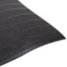 A black vinyl anti-fatigue mat with a ribbed wavy pattern.