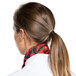 A woman wearing an Intedge chili pepper patterned chef neckerchief around her neck.