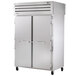 A white True Spec Series reach-in refrigerator with a solid front door and a glass back door.