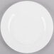 A Homer Laughlin Pristine Ameriwhite china plate with a white rim on a gray surface.