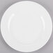 A Homer Laughlin Pristine Ameriwhite china plate with a white rim on a gray surface.