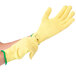 A pair of yellow Cordova cut resistant gloves with green trim on a white background.