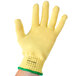 A yellow Cordova cut resistant glove with a green band.