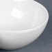 A close-up of a white CAC tasting dish with three bowls.