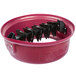 A red bowl with black metal objects inside.