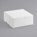 A 9" x 9" x 4" white cake box with a lid.