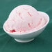 An Arcoroc Ludico porcelain bowl filled with pink ice cream.