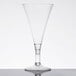 A clear plastic Fineline Tiny Barware champagne flute on a table.