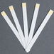 A group of white paper strips with yellow edges.