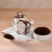 A bowl of ice cream with Dutch Treat chocolate sundae "dirt" powder and a spoon.