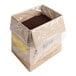 A brown box with a plastic bag of brown Dutch Treat sundae dirt inside.