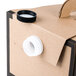 A close up of a Sabert cardboard box with a white lid and a black lid.