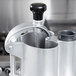 A stainless steel Robot Coupe food processor pusher assembly.