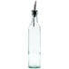 A clear glass Tablecraft olive oil cruet with a metal pourer.